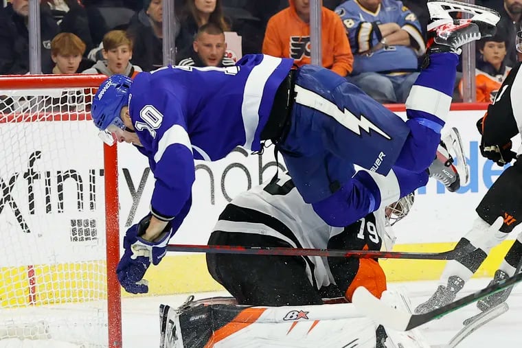 Lightning right wing Corey Perry dives over Flyers goaltender Carter Hart.