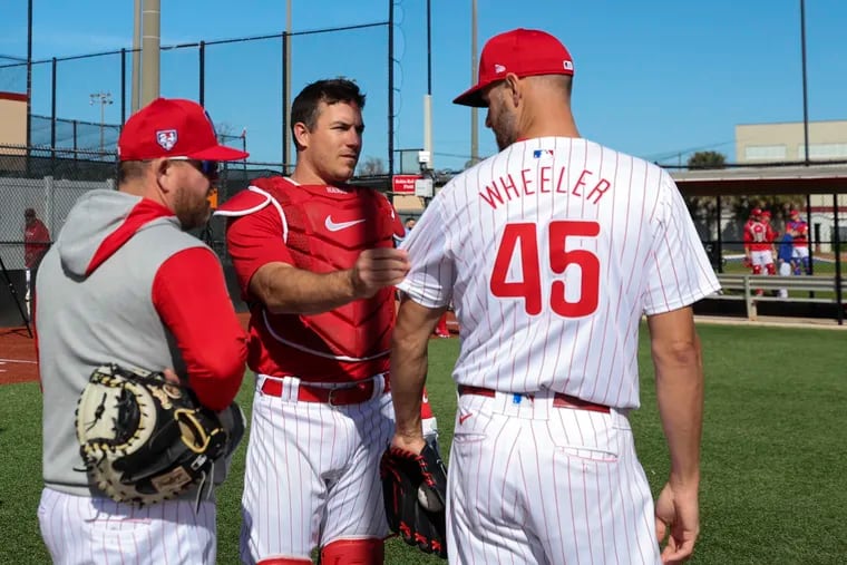Phillies catcher J.T. Realmuto touches pitcher Zack Wheeler’s new jersey at the BayCare Ballpark on the first day of spring training in Clearwater, Fla.
