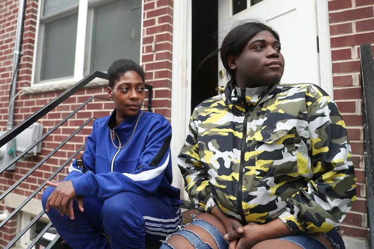 Kaprie Jones (left) and Nadia Butler outside their new home in West Philadelphia. Both were previously experiencing homelessness until taking part in a new project that pays rent to landlords for young LGBTQ tenants.