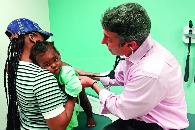 Pediatrician Dan Taylor examines a young patient, Jaleene, at the primary care clinic at St. Christopher's Hospital for Children in 2019, before COVID-19 changed so much for his practice and patients.