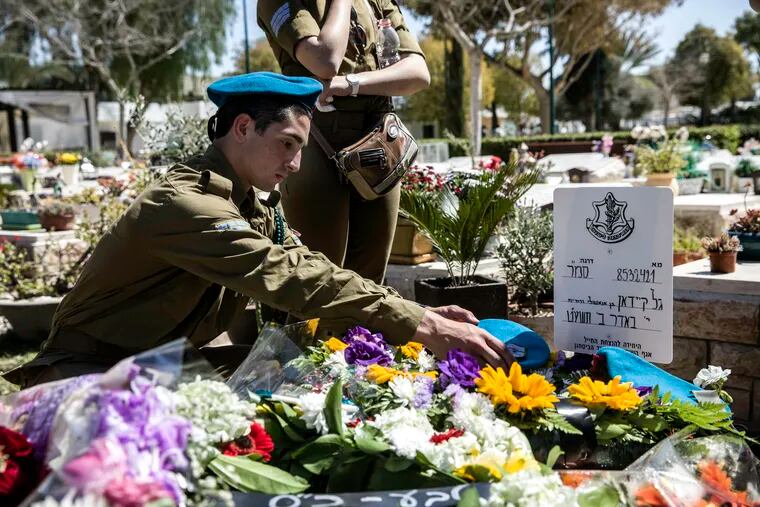 Israeli soldiers and friends of Staff Sgt. Gal Keidan mourn at his grave after the funeral in the city of Beersheba, Monday, March 18, 2019. Keidan was killed by a Palestinian assailant in the West Bank Sunday.
