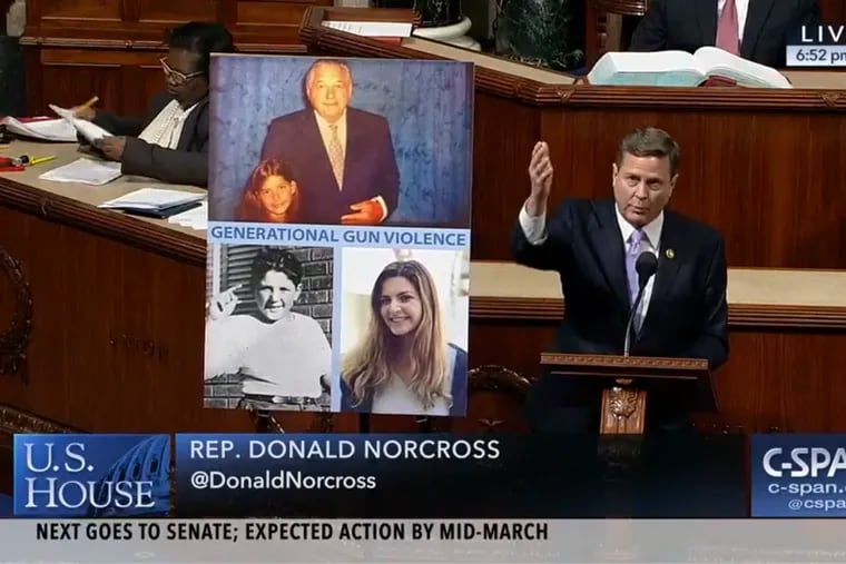 U.S. Rep. Donald Norcross (D., N.J.) speaks on the House floor on Tuesday, Feb. 26, 2019 alongside photos of Carly Novell, who survived the Marjory Stoneman Douglas High School shooting in Parkland, Fla. in 2018, and her grandfather, Charles Cohen, who escaped a mass shooting in Camden decades earlier, in 1949. Both hid in closets. Novell joined Norcross' office as an intern days before the House was expected to approve bills strengthening background checks for gun purchases.