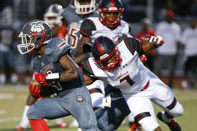 Omar Speights (right) tries to chase down a Simon Gratz ballcarrier in Imhotep Charter’s 40-21 victory last season.