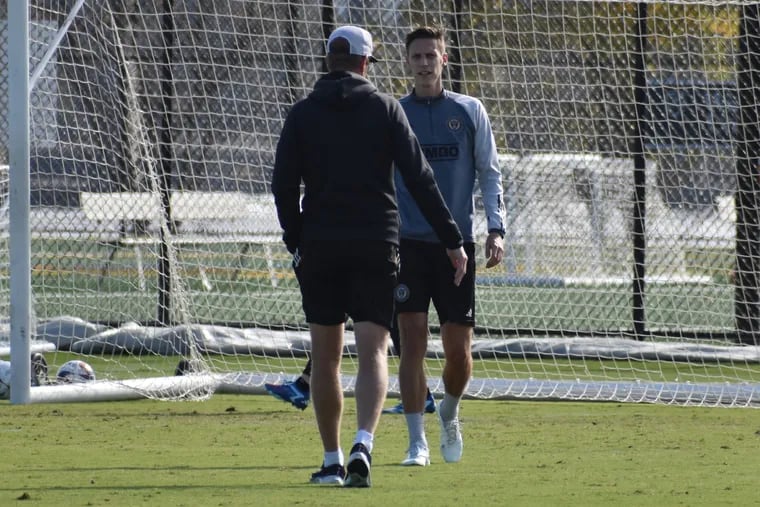 Jack Elliott (right) chatting with Union manager Jim Curtin during Tuesday's practice.
