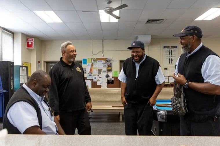 Otis Barnes of Southwest Philadelphia, a bus operator for SEPTA (center right), chatting with Brian Pollitt, president of TWU Local 234, (center left), along with coworkers at the Callowhill Depot in West Philadelphia in July.