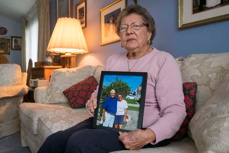 Friday September 30, 2016  Marie Wrigley sits in her Abington home holding a photo of she and her husband John in happier days at their summer home in Brigantine. John died last February and his wife is angry at three area nursing homes she says mistreated him., ED HILLE / Staff Photographer