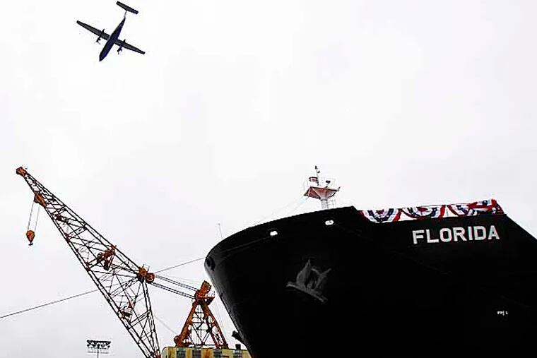 A plane passes over the Florida, a tanker, before it's owner, Crowley Maritime Corporation, christens it at Aker Philadelphia Shipyard in the Navy Yard in Philadelphia, Pa., on January 30, 2013.  ( DAVID MAIALETTI / Staff Photographer ) Navy03