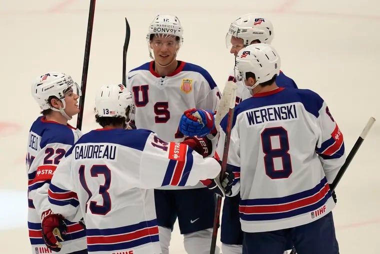 The United States' Brady Tkachuk celebrates with Johnny Gaudreau and teammates after scoring his side's fourth goal against Kazakhstan.