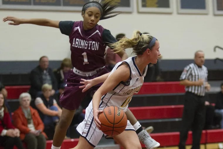 Academy of Notre Dame, Mandy McGurk, right, 11, drives by Abington High School, Jordyn Allen, 1, during the first quarter of the game in the 2017 December Classic Tournament at Germantown Academy High School.