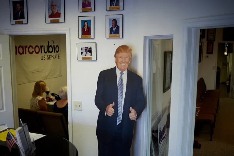 A cardboard cutout of President Donald Trump greets visitors to the Lee County (Fla.) Republican Headquarters office.
