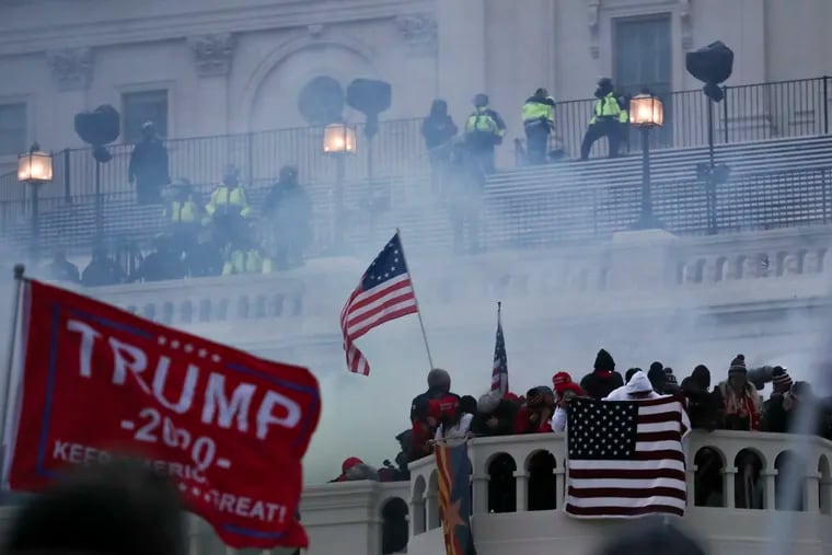 Smoke can be seen outside of the U.S. Capitol while police disperse insurrectionists hours after a mob of Trump supporters breached the building on Jan. 6, 2021.