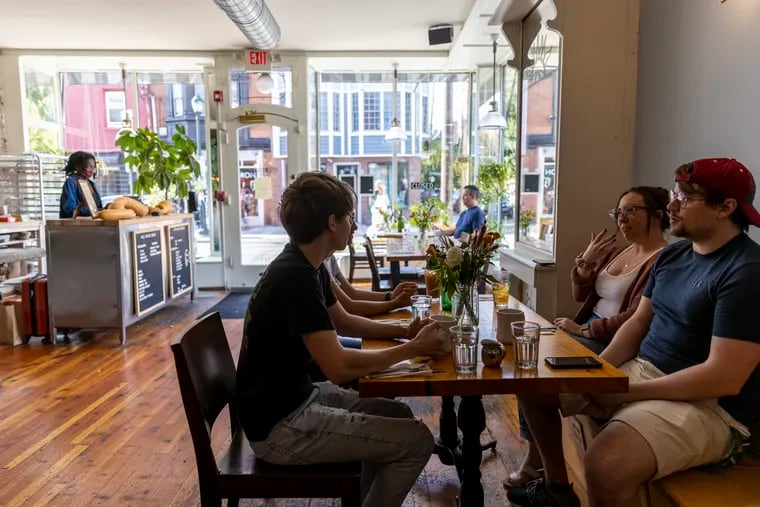 Customers enjoying their food and beverages in the indoor dining at Fitz and Starts. You can no longer eat indoors in Philadelphia without a vaccine card.