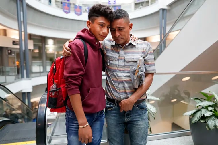 Edvin Cazun, of Guatemala, right, hugs his son Samuel at Cincinnati/Northern Kentucky International Airport as they reunite Monday after being separated about a month ago at the southern border. Edvin said he spent 15 days without knowing anything about his son.