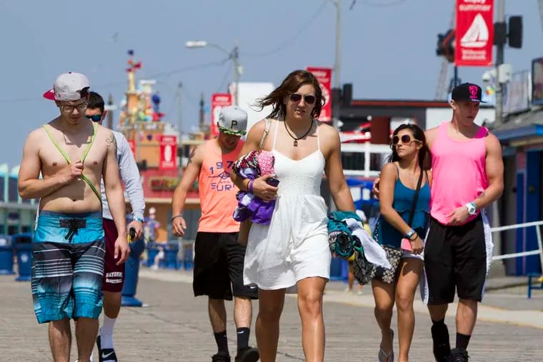 A wide variety of sartorial styles is on display on the boardwalk in Wildwood. A proposed ordinance would ban sagging pants and going shirtless after sunset, or shoeless anytime. Violators could pay $25; repeat offenders, possibly more. DAVID M WARREN / Staff Photographer