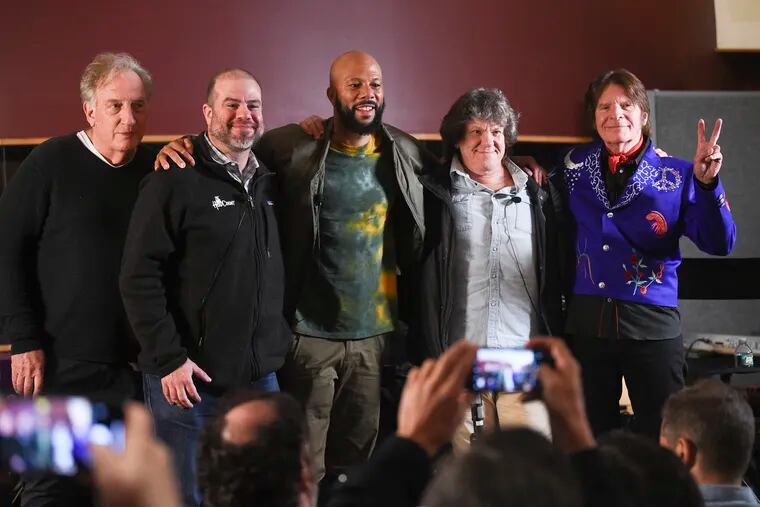 FILE - In this March 19, 2019, file photo (from left) comedy writer Alan Zweibel; HeadCount executive director Andy Bernstein; hip hop recording artist Common; Woodstock co-producer and co-founder, Michael Lang; and musician John Fogerty participate in the Woodstock 50 lineup announcement at Electric Lady Studios in New York. (Photo by Evan Agostini / Invision / AP, File)