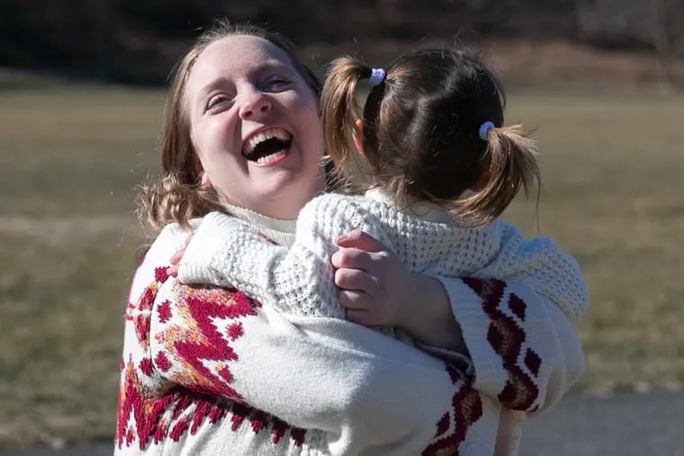 Samii Emdur holds her adopted daughter, Jordan Emdur, 2, while they play together at Connolly Park near their home in Voorhees, NJ on Saturday, Jan. 30, 2021. Emdur, a CHOP nurse, just won a $100,000 grant for her camp that reunites siblings separated by foster care.