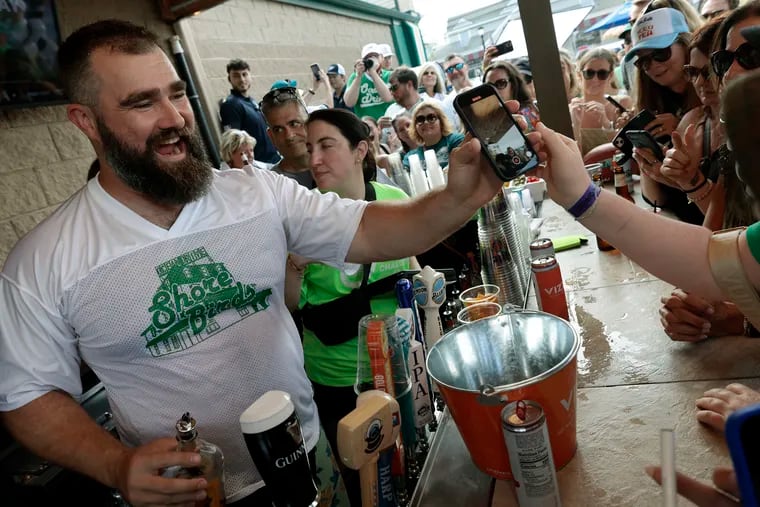 Jason Kelce takes selfies and pours fireballs while bartending at O'Donnell's Pour House in Sea Isle City, N.J., on June 28, 2023.