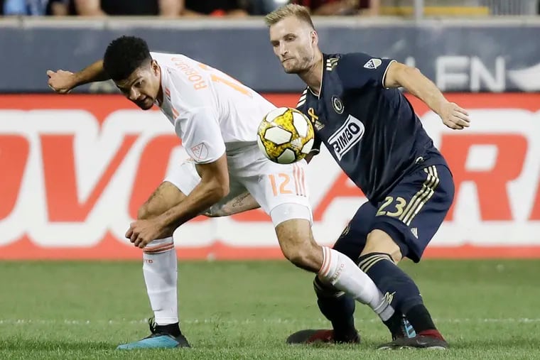 Union forward Kacper Przybylko and Atlanta United FC defender Miles Robinson go after the soccer ball during the second-half on Saturday, August 31, 2019 in Chester.