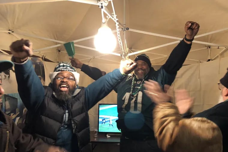 Thomas “Fattz” Walker and Derrick “Big Derrick” Simmons celebrate in their tent outside the Linc after the Eagles victory.