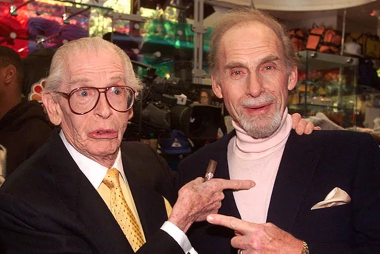 FILE - This Oct. 25, 1999 file photo shows Milton Berle, left, and Sid Caesar before being honored in as the first inductees into NBC's "Walk of Fame" in the network's Rockefeller Center store in New York. Caesar, whose sketches lit up 1950s television with zany humor, died Wednesday, Feb. 12, 2014. He was 91.  (AP Photo/Richard Drew, File)