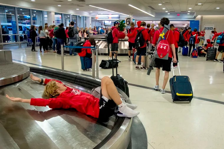 Freshman Jack Schiavo waits on an empty luggage carousel at Philadelphia International Airport.