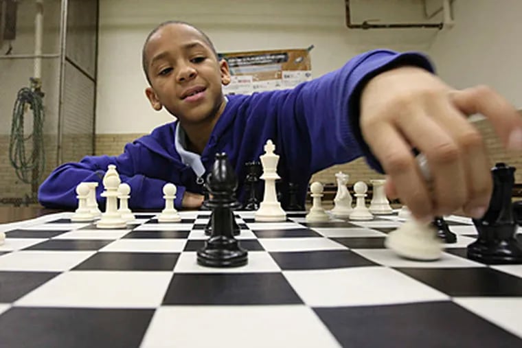 STEVEN M. FALK / STAFF PHOTOGRAPHER Nifese Hopkins has checkmate on his mind as a member of the Mitchell Elementary chess team. A group of local student players are looking to compete in a national tournament in April.