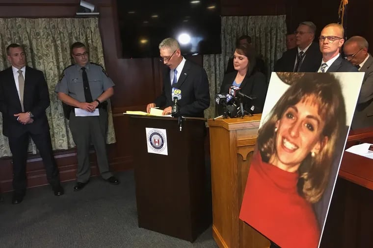 Lancaster County District Attorney Craig Stedman announces charges in a 1992 cold case killing during a news conference at the Lancaster County Courthouse in Lancaster, Pa., Monday, June 25, 2018. A family photo of the victim, Christy Mirack, is seen at right. A popular DJ in Pennsylvania has been charged in the 1992 killing of Mirack, an elementary school teacher who was sexually assaulted, beaten and strangled in her home as she was getting ready for work.