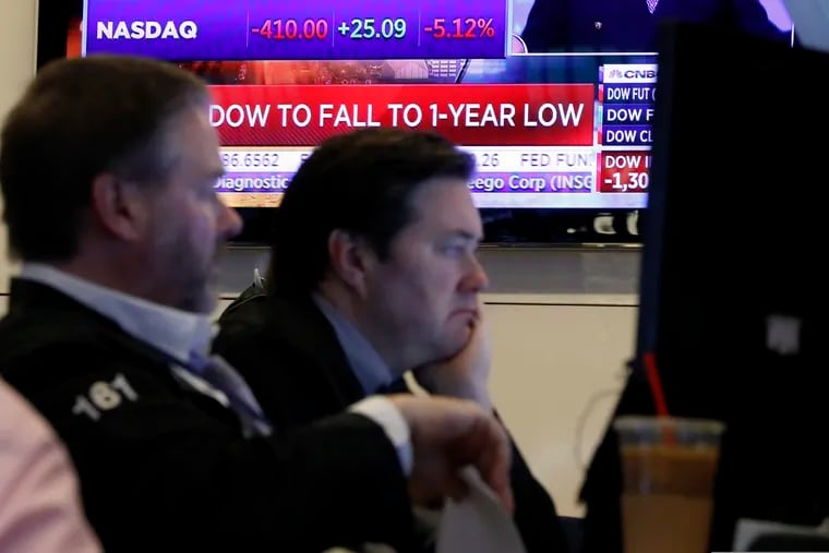 A television screen shows headlines as traders prepare for the day's activity on the floor of the New York Stock Exchange on Monday.