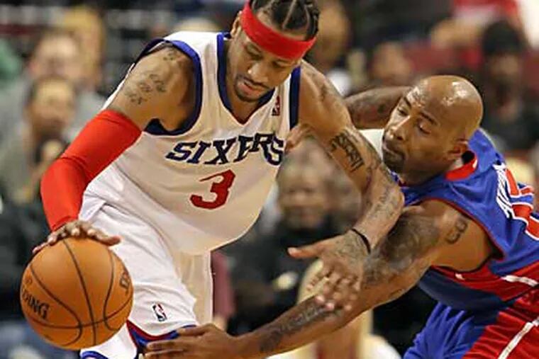 The Sixers' Allen Iverson tries to get around Pistons' Chucky Atkins
during the 2nd quarter.  The Pistons won 90-86.  (Steven M. Falk / Staff Photographer )