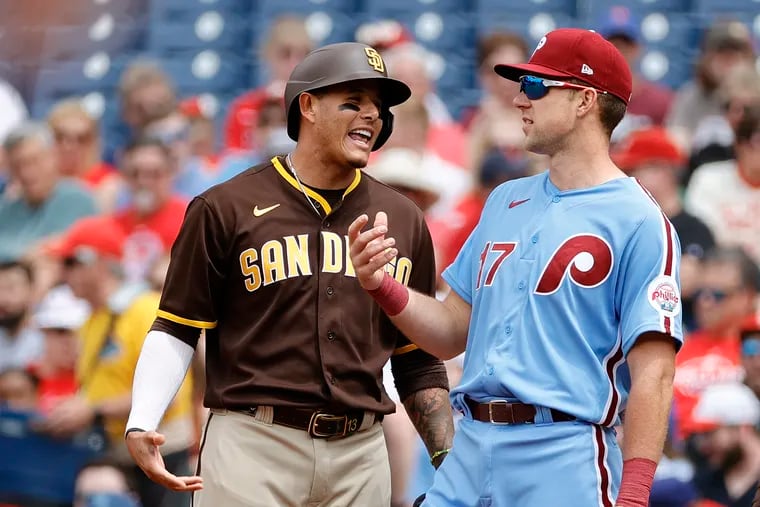 San Diego Padres third baseman Manny Machado (left) and Philadelphia Phillies first baseman Rhys Hoskins (right) talk during a game at Citizens Bank Park. (Photo by Tim Nwachukwu/Getty Images)