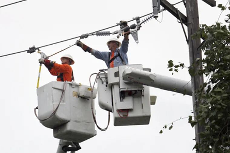 Peco's price for residential electric power has gone up 12 percent this year. Above, a repair crew in Chester County after Hurricane Irene downed lines. (Laurence Kesterson / Staff Photographer)