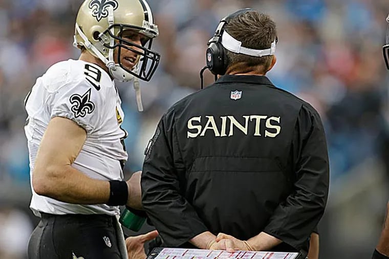 The Saints' Drew Brees talks with head coach Sean Payton. (Bob Leverone/AP)