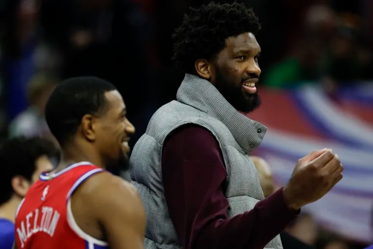 Sixers center Joel Embiid watching the game against the Sacramento Kings on Friday in street clothes.