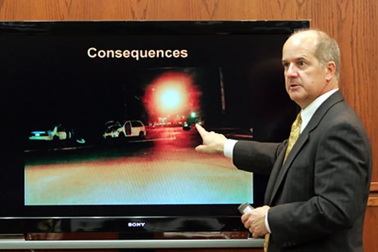 Prosecutor J. David Meyer presents photographic details of the accident scene during the opening arguments in the vehicular homicide trial of New Jersey State Trooper Robert Higbee.  Higbee is accused in the deaths of Upper Township sisters Jacqueline and Christina Becker stemming from a Sept. 27, 2006  traffic accident. (AP Photo/The Press of Atlantic City, Dale Gerhard)
