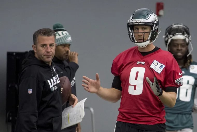 Starting quarterback Nick Foles talks with quarterbacks coach John DeFilippo as the Eagles practice for their upcoming game against the New York Giants inside The Bubble at the Nova Care Complex December 13, 2017. CLEM MURRAY / Staff Photographer