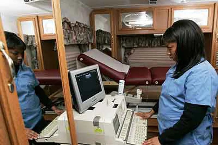 An ultrasound technician at an ultrasound machine in a motor home parked outside an abortion clinic in Englewood, N.J., in 2007. Pennsylvania legislators are dealing with a proposal to require an ultrasound. (AP Photo / Mike Derer)