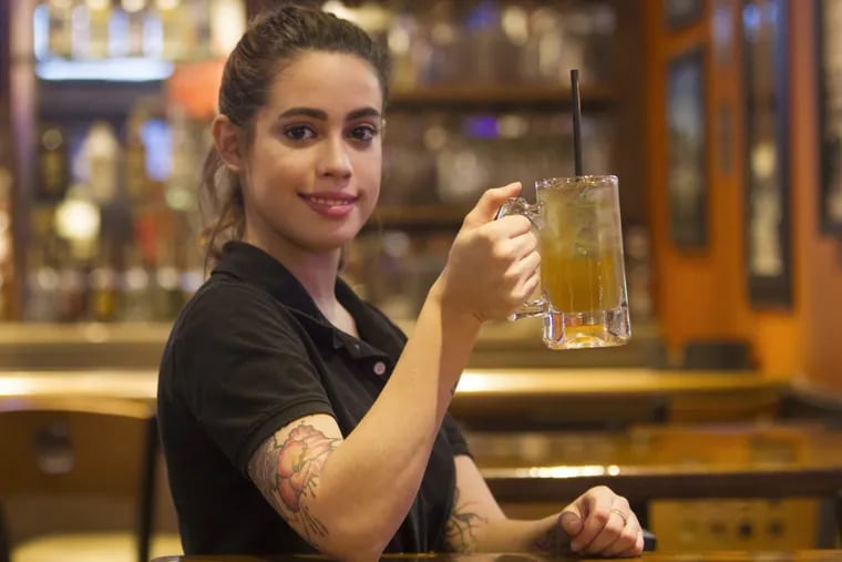 Bartender Sabrina Mendez holds a Dollar L.I.T. special at Applebee’s Neighborhood Grill &amp; Bar in Havertown.