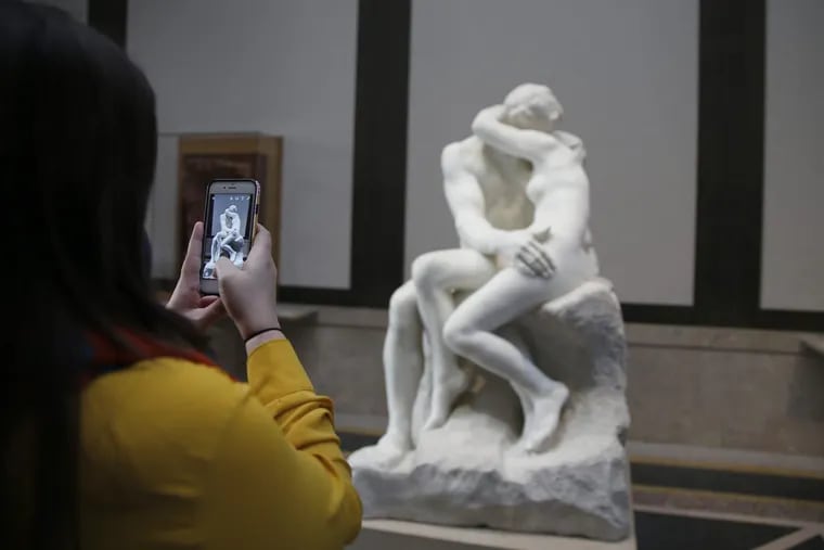 An unidentified woman photographs a copy of Rodin’s “The Kiss” at  the Rodin Museum. The museum unveiled a new exhibition around the theme of passionate embrace early in 2017.  DAVID MAIALETTI / Staff Photographer