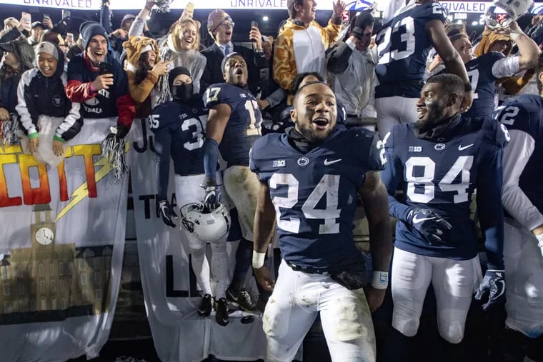 Penn State running back Miles Sanders (24) and his teammates celebrate a 30-24 win against Iowa with the student section at Beaver Stadium on Oct. 27.