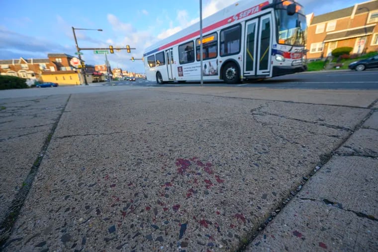A SEPTA bus on Thursday drove by the blood-stained sidewalk on Bustleton Avenue near St. Vincent Street in Northeast Philadelphia hours after three teens with gunshot wounds had gotten off a Route 58 bus.