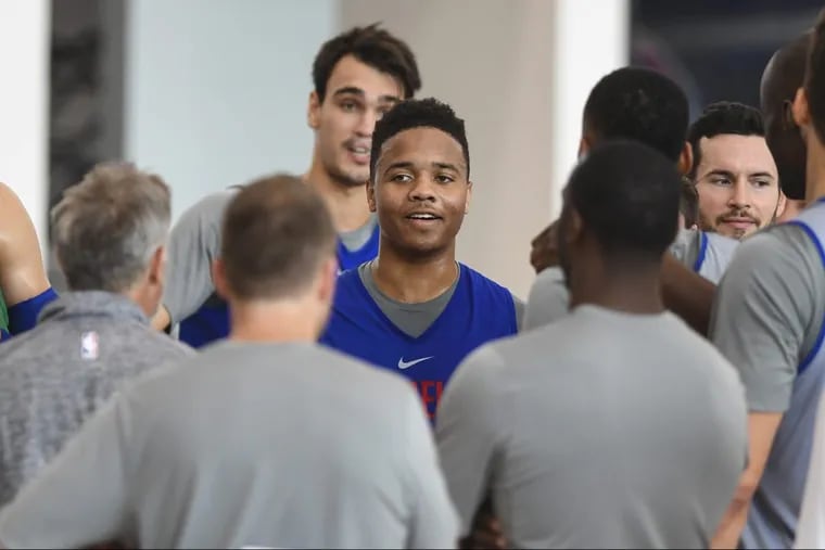 Markelle Fultz stands out as the team huddles with coach Brett Brown (left) at a practice in Camden.