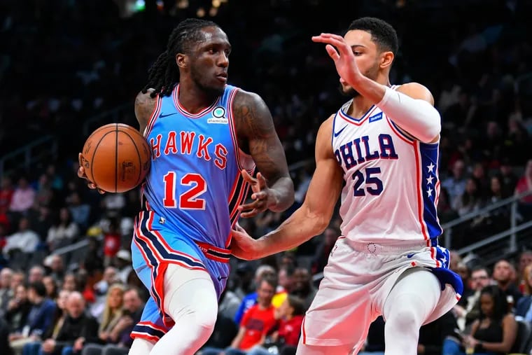 Hawks forward Taurean Prince (12) drives against 76ers guard Ben Simmons during the first half.