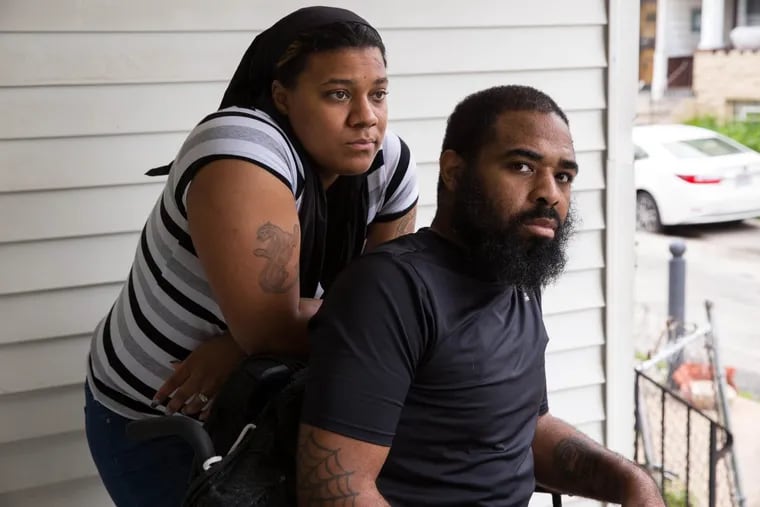 Tamira Brown and Jalil Frazier on the front porch, where steep stairs leading to the sidewalk pose a major obstacle for Jalil.