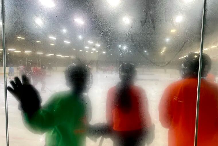 November 22, 2021: The glass in one section of the rink is clouded from the cold during an Ed Snider Youth Hockey Foundation practice at the Laura Sims Skate House in Cobbs Creek.