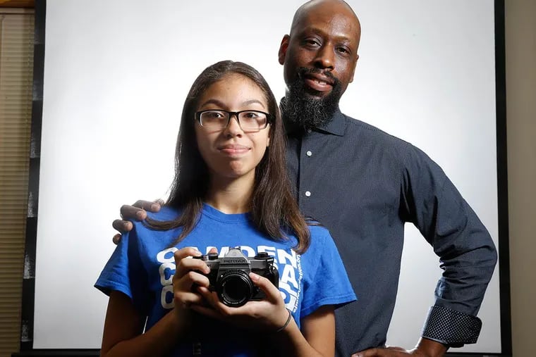 Abigail Rivera, foreground, is a budding photographer from Camden whose talents have been nurtured by professional shooter Erik James Montgomery, background, and his EJM Foundation.