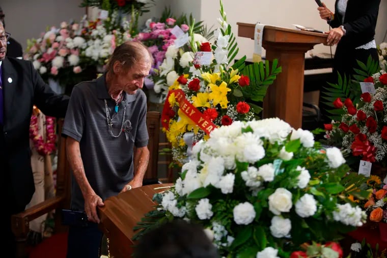 Antonio Basco, companion of Margie Reckard, leans on her casket during her funeral at La Paz Faith Memorial & Spiritual Center, Friday, Aug. 16, 2019, in El Paso, Texas. Reckard was killed during the mass shooting on Aug. 3.