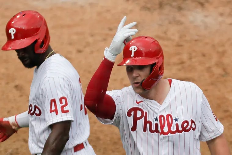 Phillies Rhys Hoskins celebrates his fifth inning three run home run with teammate Andrew McCutchen against the Atlanta Braves on Saturday, August 29, 2020 in Philadelphia.
