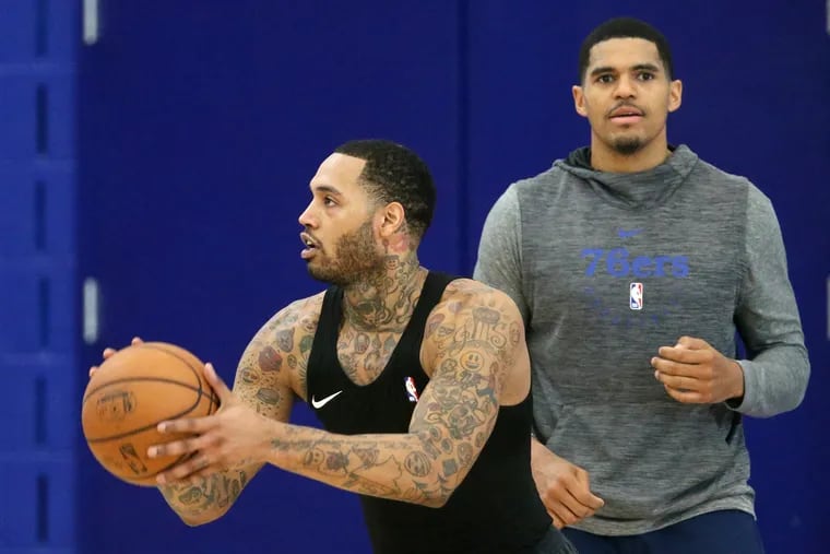 The Sixers' Mike Scott, left, shooting during practice near teammate Tobias Harris at the Sixers Training Complex on Wednesday in Camden.