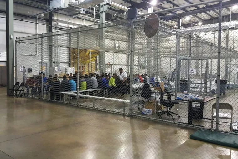 People taken into custody related to cases of illegal entry into the United States are shown at a facility in McAllen, Texas, Sunday, June 17, 2018.