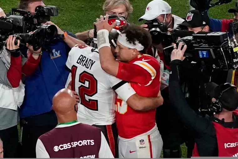 Tampa Bay's Tom Brady and Kansas City's Patrick Mahomes embrace  after the Buccaneers beat the Chiefs in Super Bowl LV.